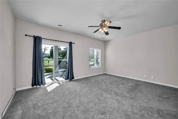 a view of a livingroom with a ceiling fan and window
