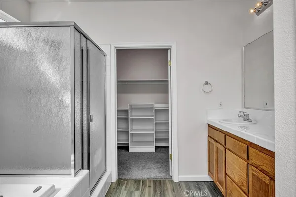a hallway with closet and wooden floor