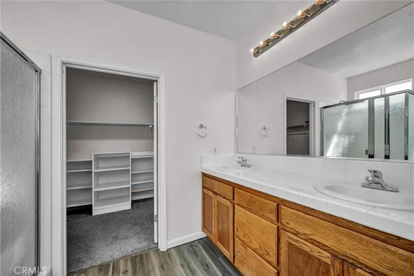 a bathroom with a sink double vanity and a mirror