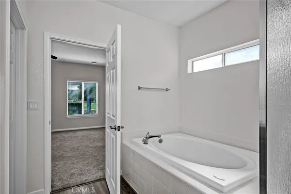 a bathroom with a tub shower and sink