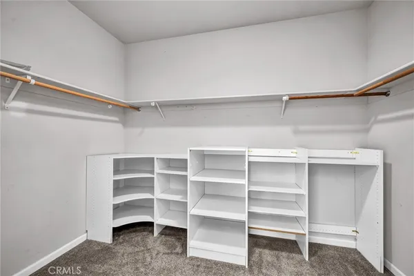 a view of walk in closet with empty racks