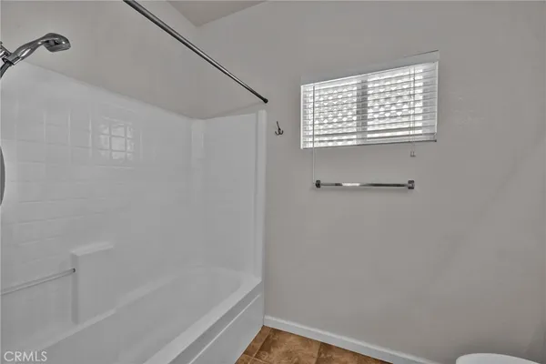 a bathroom with a bathtub and shower