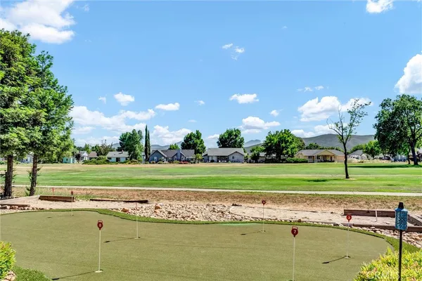 a view of a golf course with a lake view