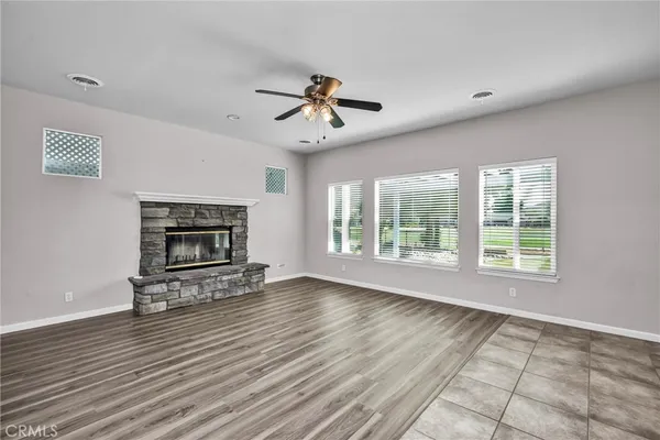 a view of an empty room with a fireplace and a window