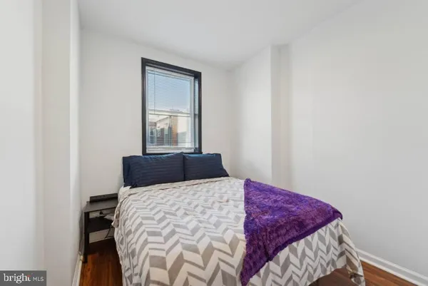 a bedroom with a bed and window