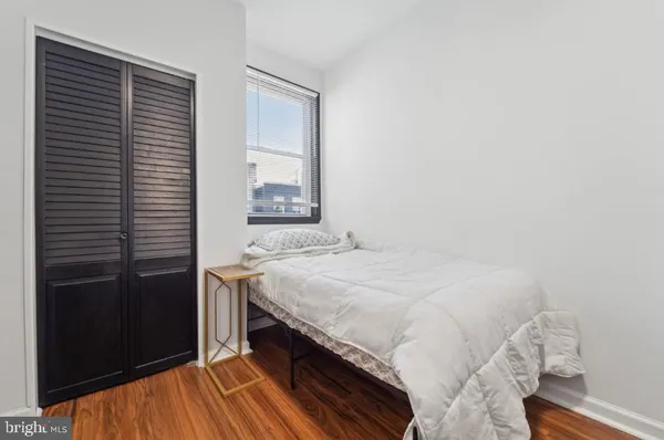 a bedroom with a bed and a window