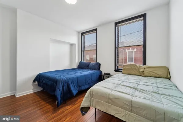 a bedroom with two beds and a window