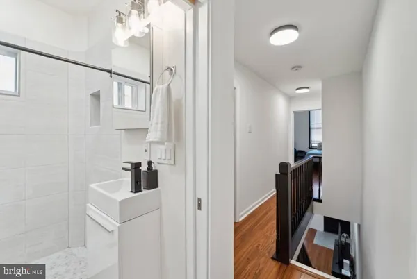 a bathroom with a sink a mirror and a shower