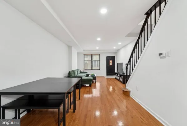 a view of a dining room with furniture and wooden floor