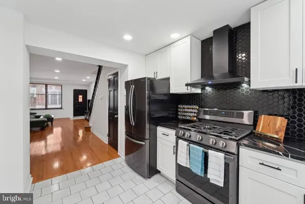a kitchen with stainless steel appliances granite countertop a refrigerator stove and oven