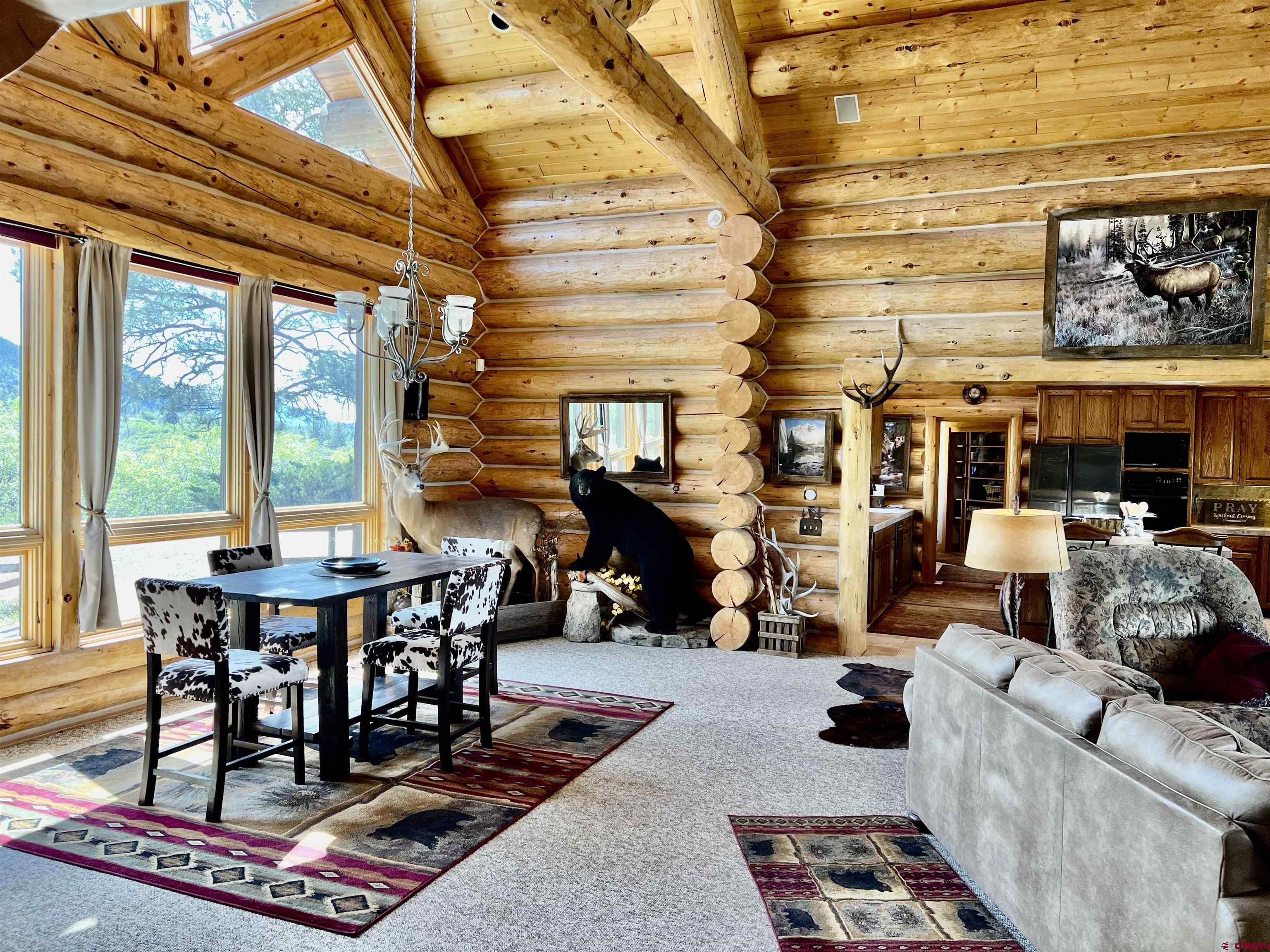 1329 B Spg Vly Rnch Road, Unit ELK HAVEN Chromo, CO 81128 - Photo 11 of 33 a living room with furniture a rug and a floor to ceiling window