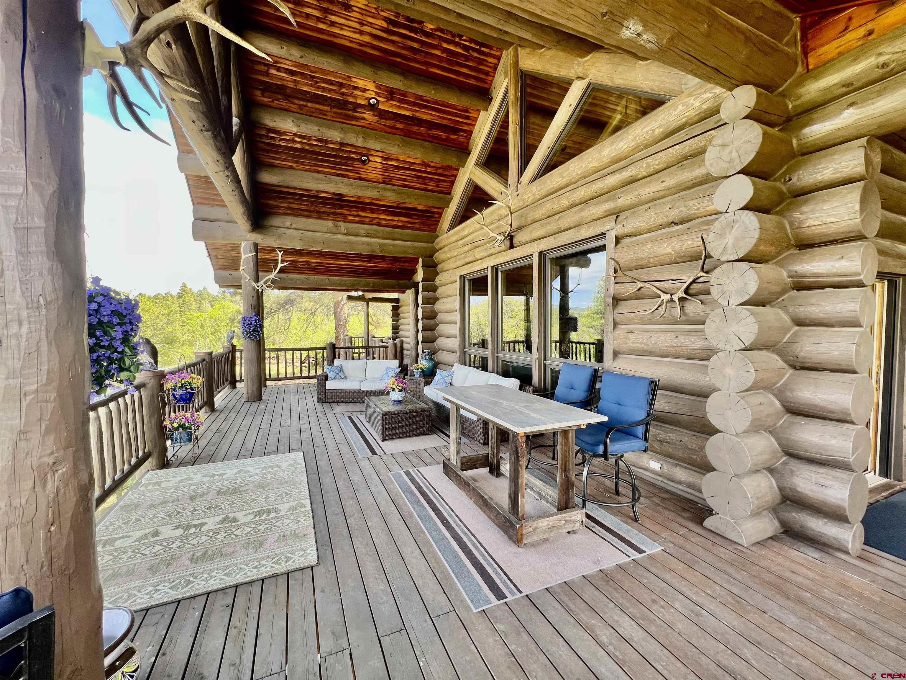1329 B Spg Vly Rnch Road, Unit ELK HAVEN Chromo, CO 81128 - Photo 23 of 33 a view of a patio with table and chairs with wooden floor and fence