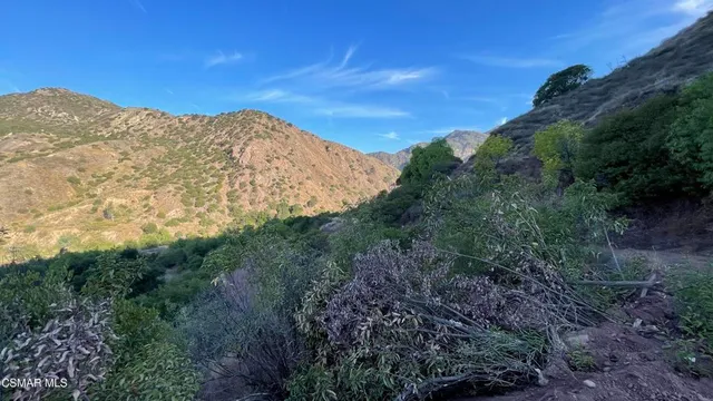 a view of a large mountain with mountains in the background