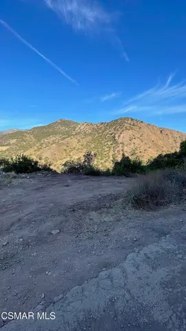 a view of an ocean beach and mountain