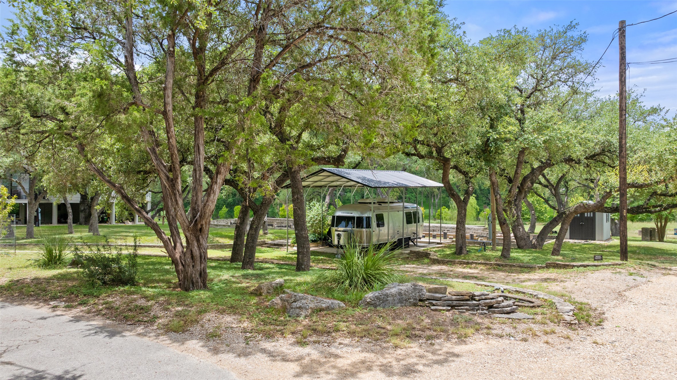 200 Rim Road Wimberley, TX 78676 - Photo 13 of 25 Existing build area and slab - current owner has Airstream (also availabel for purchase) with carport and storage shed.