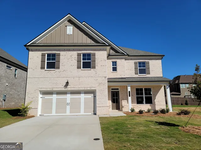 a front view of a house with a yard and garage