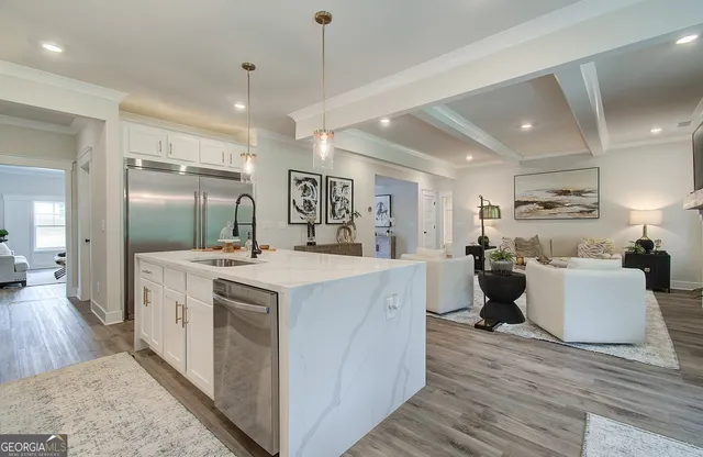 a large kitchen with stainless steel appliances a large center island in it