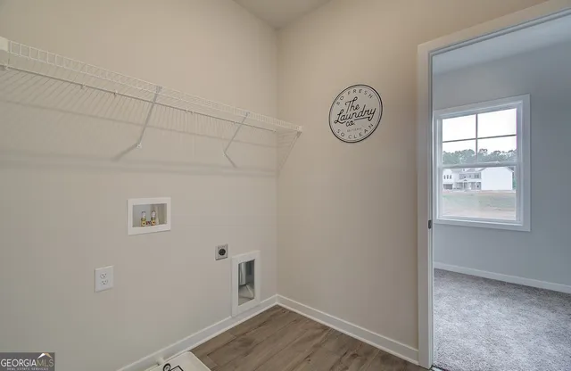 a view of a room with rack on the wall and a window