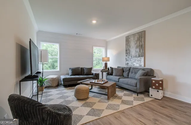 a living room with furniture and a flat screen tv