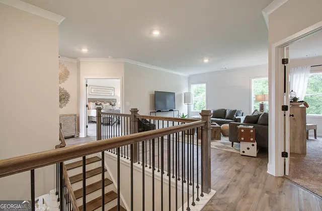 a view of a hallway with workspace and wooden floor