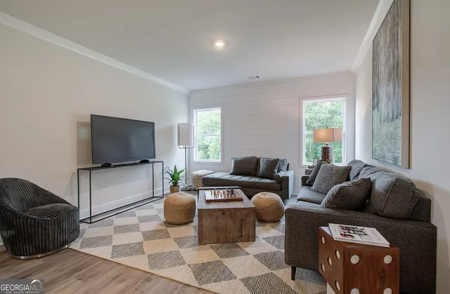 a living room with furniture and a flat screen tv