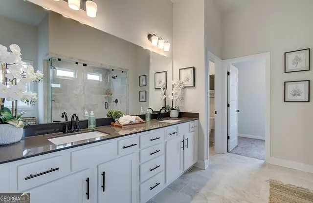 a spacious bathroom with double sink and a mirror