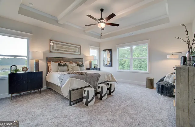 a spacious bedroom with a bed and a desk