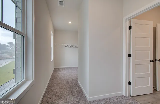 a work room with furniture and a large window