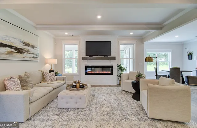 a living room with furniture fireplace and flat screen tv