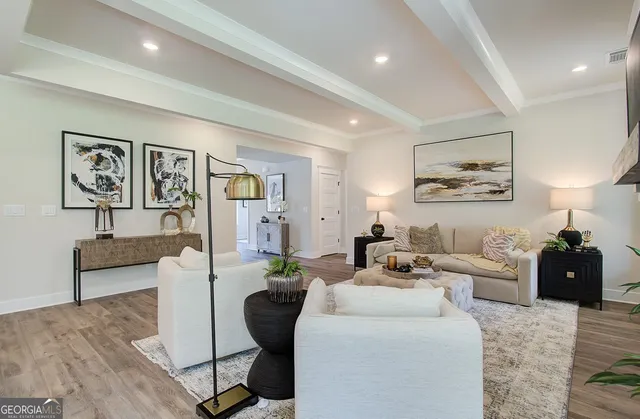 a living room with furniture and wooden floor