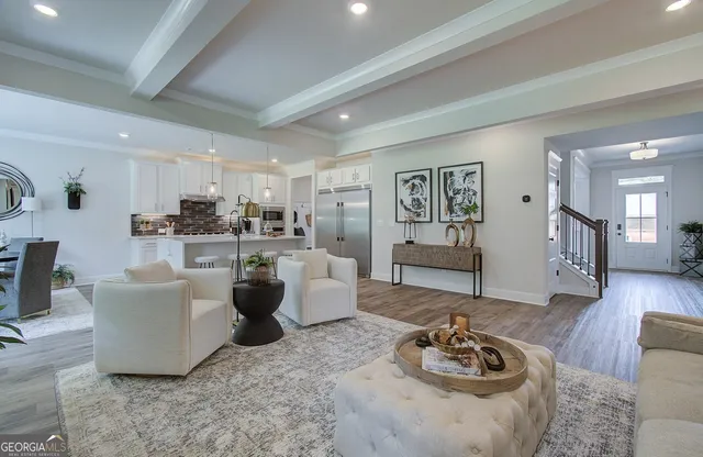 a living room with furniture and wooden floor