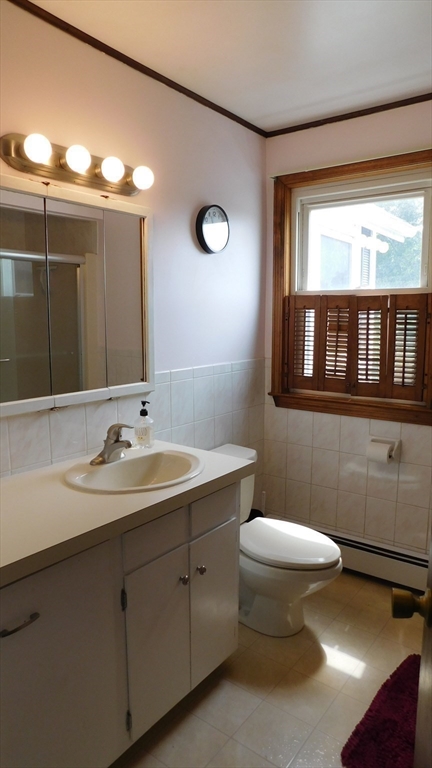 414 Cedar Street Dedham, MA 02026 - Photo 19 of 24 a bathroom with a toilet a sink and mirror