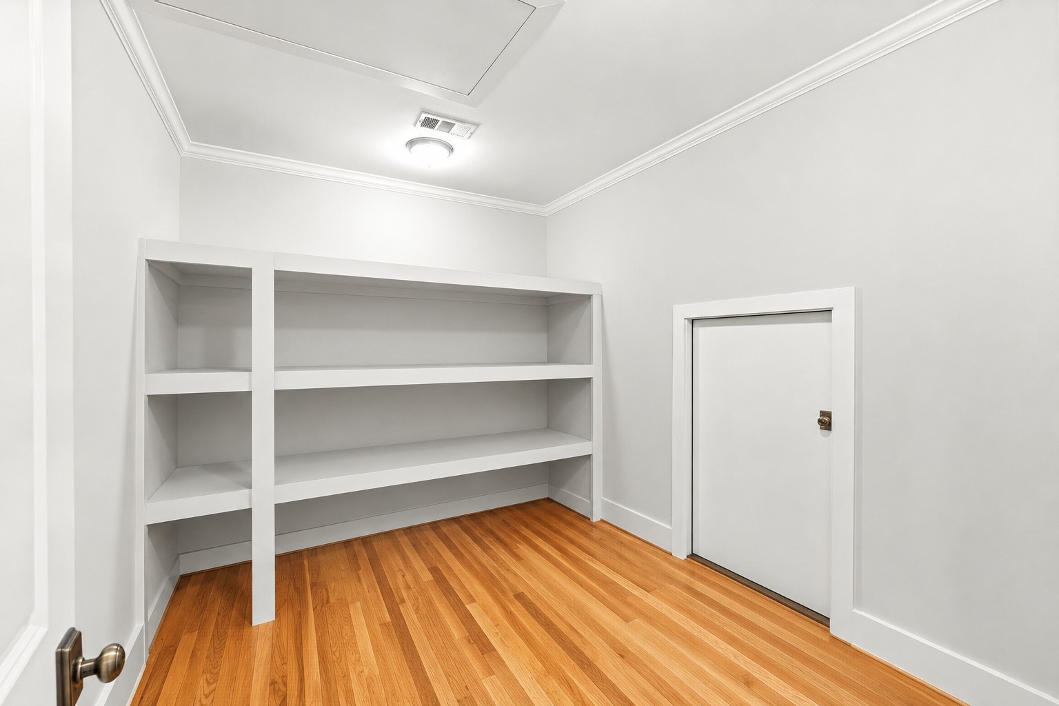 1013 Martin Street Houston, TX 77018 - Photo 35 of 46 Flexible upstairs bonus room, currently used for storage, but could make an ideal gym, media room, hobby space, or additional flex area. Easy access to floored attic storage + built-in shelving.