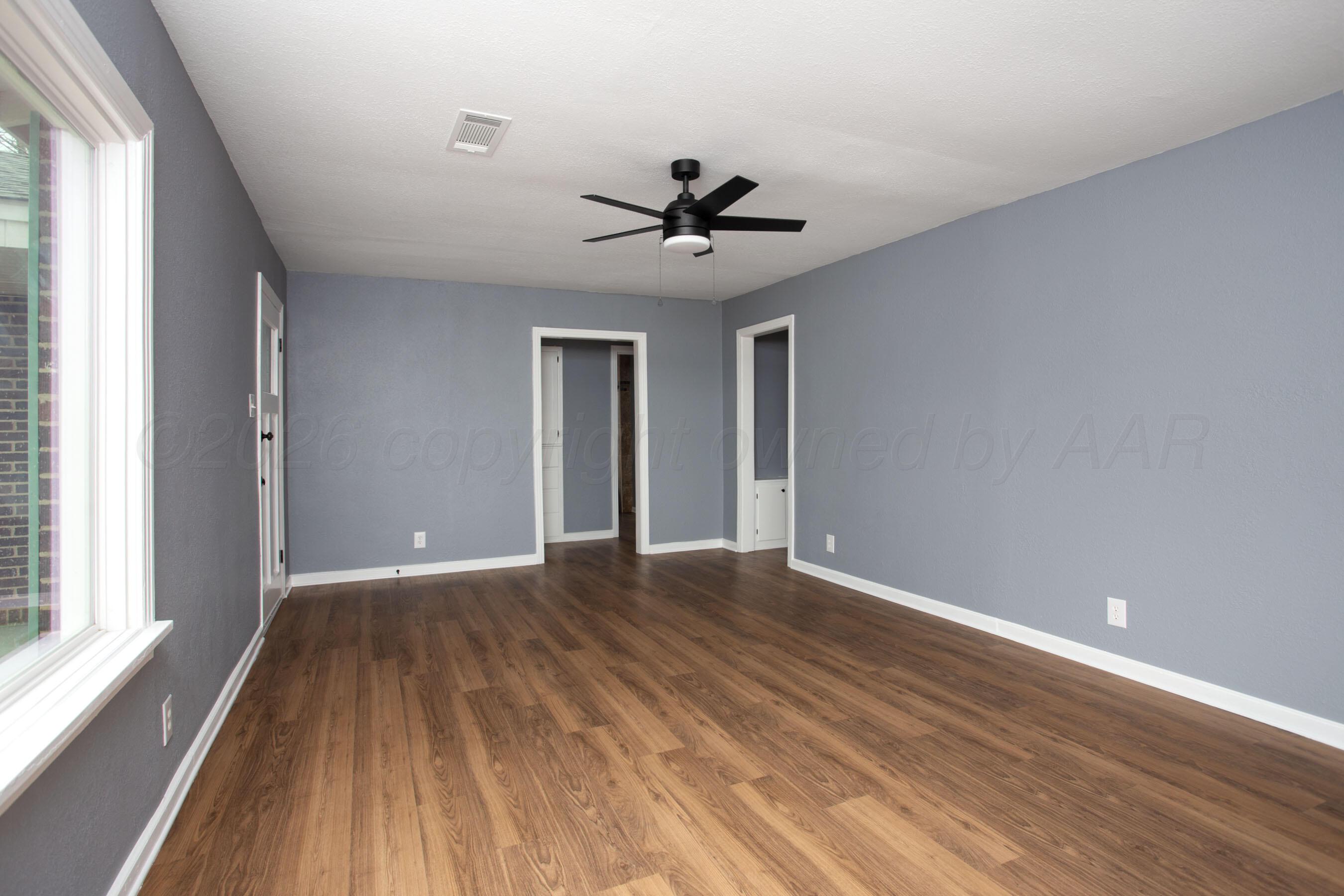 4815 Southwest 10th Avenue Amarillo, TX 79106 - Photo 12 of 21 wooden floor in an empty room with a window