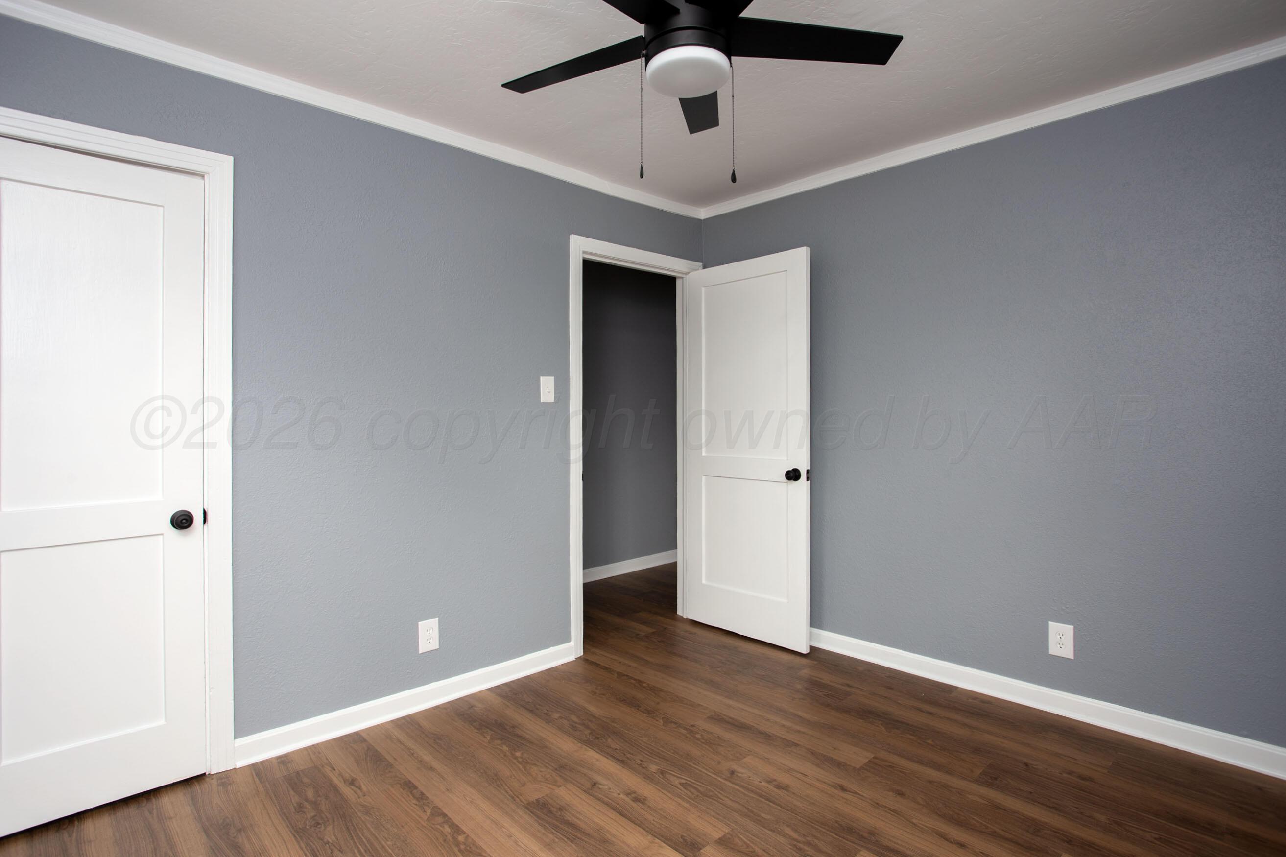 4815 Southwest 10th Avenue Amarillo, TX 79106 - Photo 17 of 21 an empty room with wooden floor ceiling fan and window