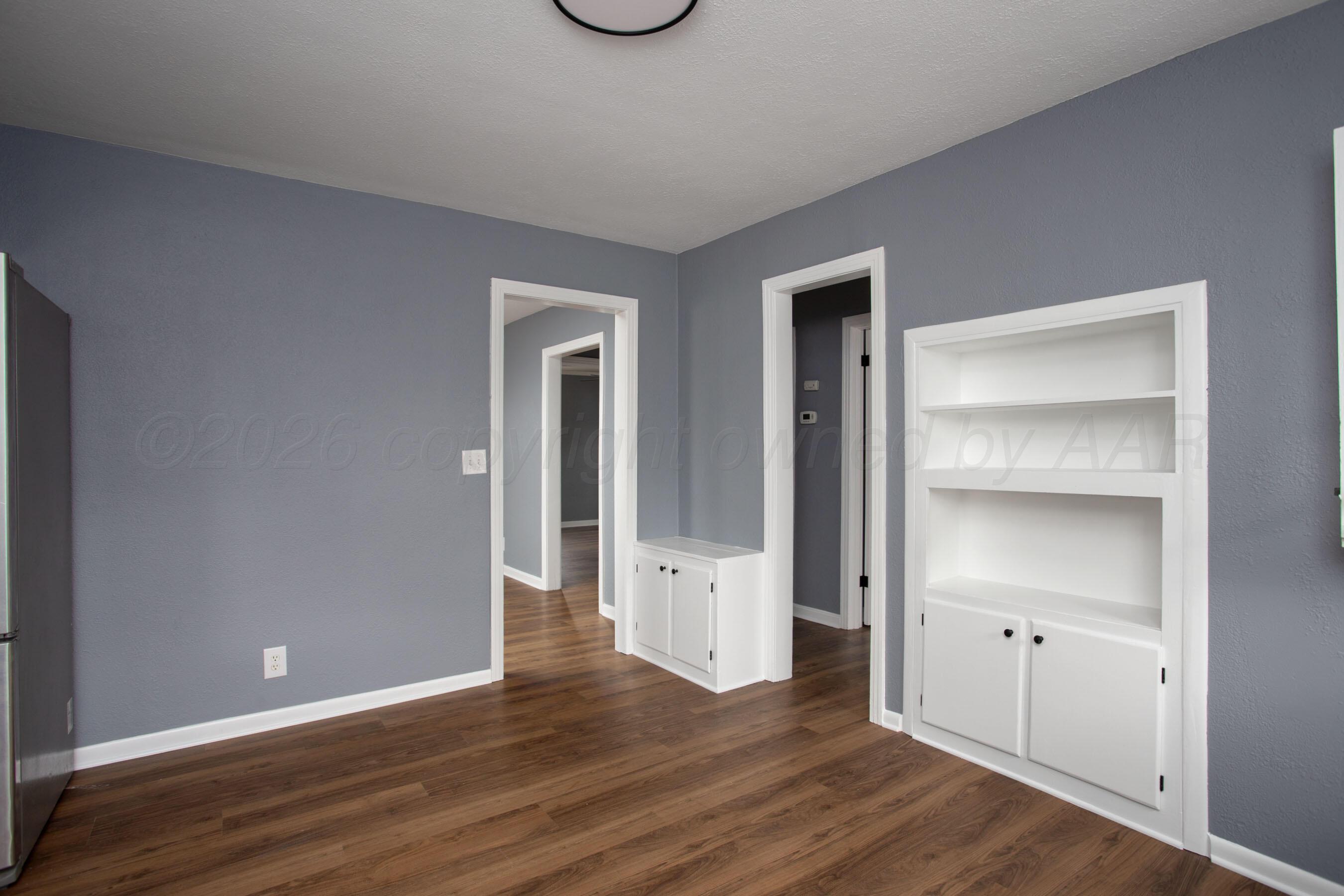 4815 Southwest 10th Avenue Amarillo, TX 79106 - Photo 4 of 21 a view of an empty room with wooden floor and closet