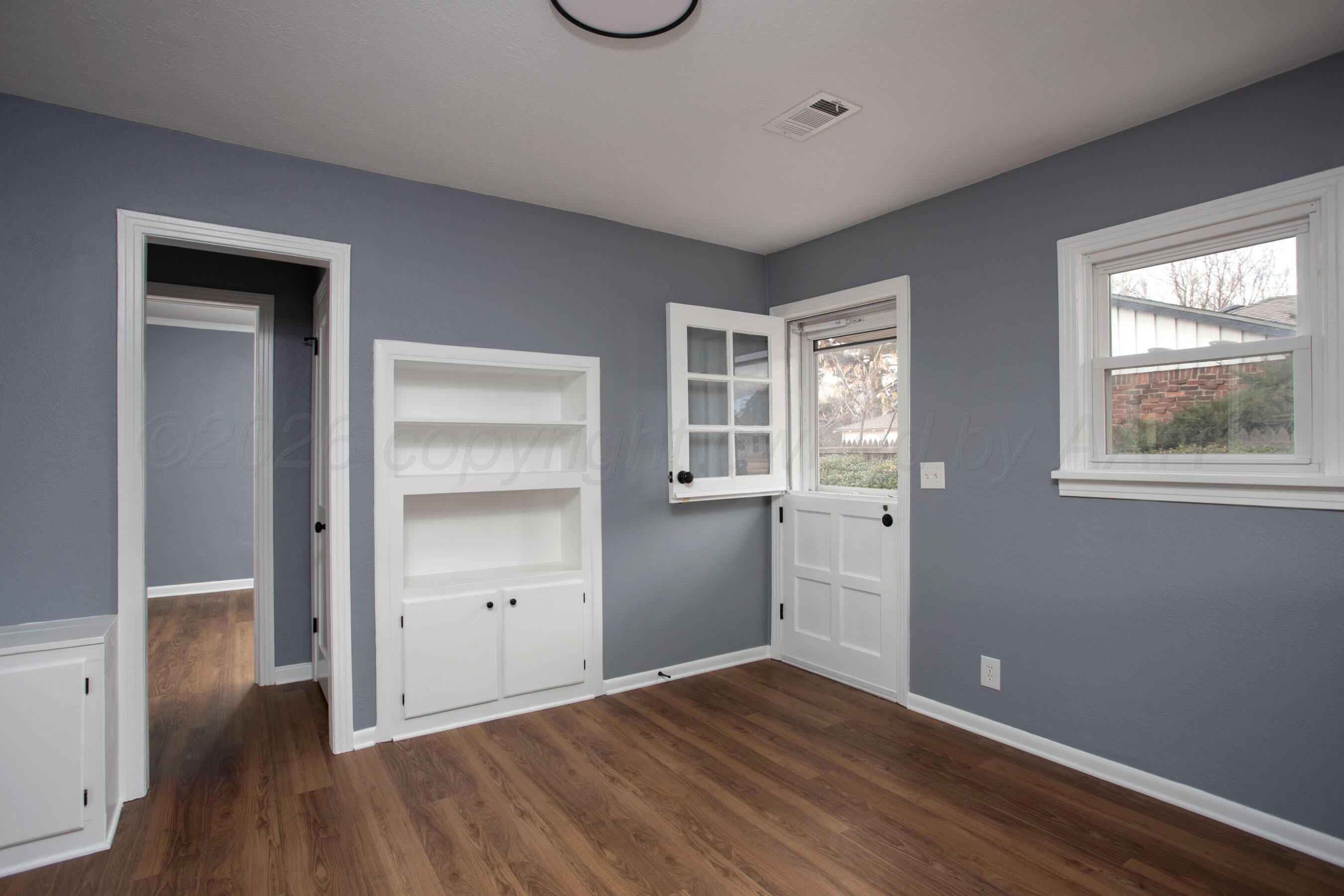 4815 Southwest 10th Avenue Amarillo, TX 79106 - Photo 5 of 21 a view of empty room with wooden floor and window