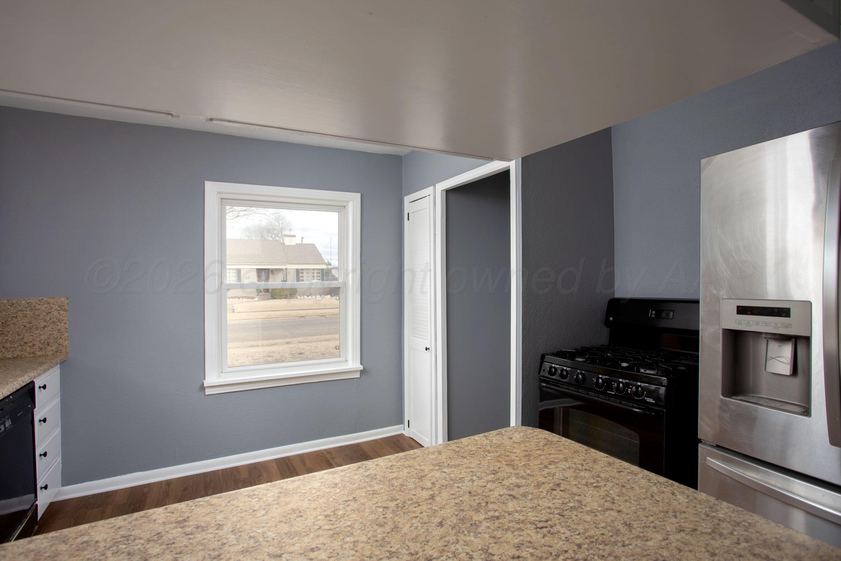 4815 Southwest 10th Avenue Amarillo, TX 79106 - Photo 8 of 21 a kitchen with a refrigerator and a stove top oven