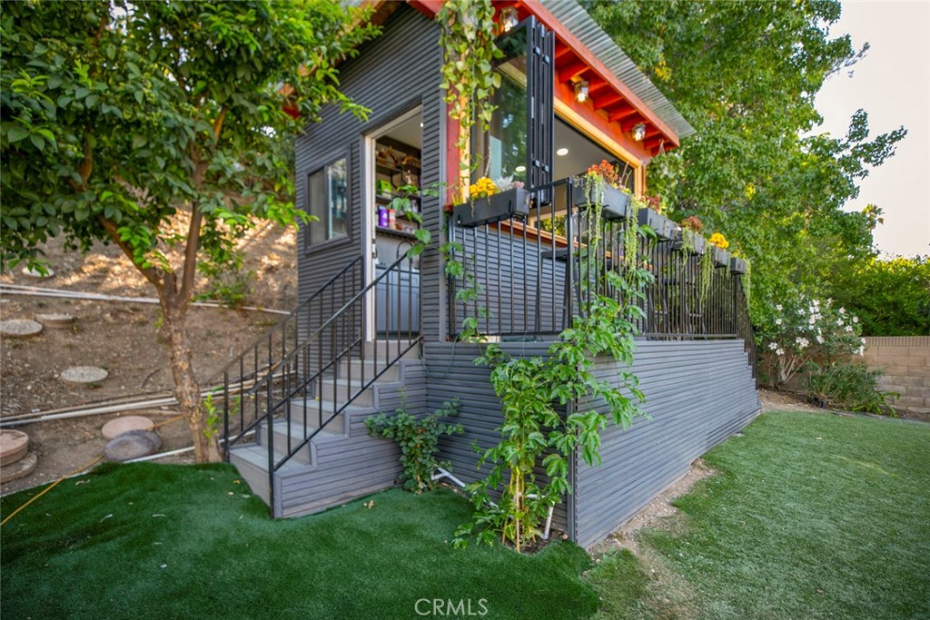 18810 Kirkcolm Lane Porter Ranch, CA 91326 - Photo 52 of 75 a view of house with a yard and potted plants
