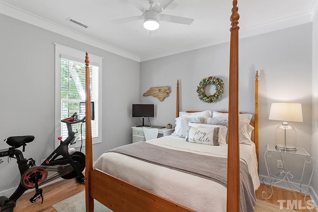 1417 Battery Drive Raleigh, NC 27610 - Photo 17 of 34 a bedroom with a bed and a chandelier