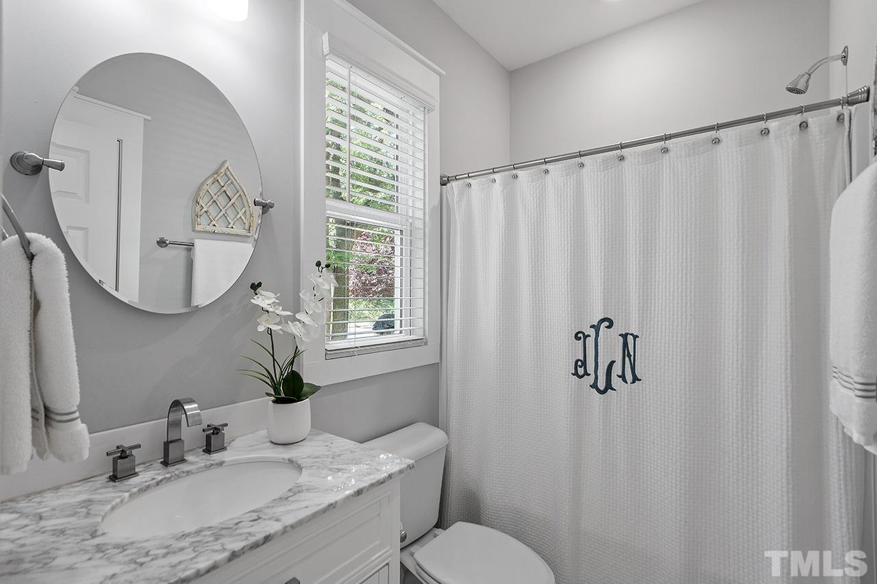1417 Battery Drive Raleigh, NC 27610 - Photo 18 of 34 a bathroom with a granite countertop sink vanity mirror and a toilet