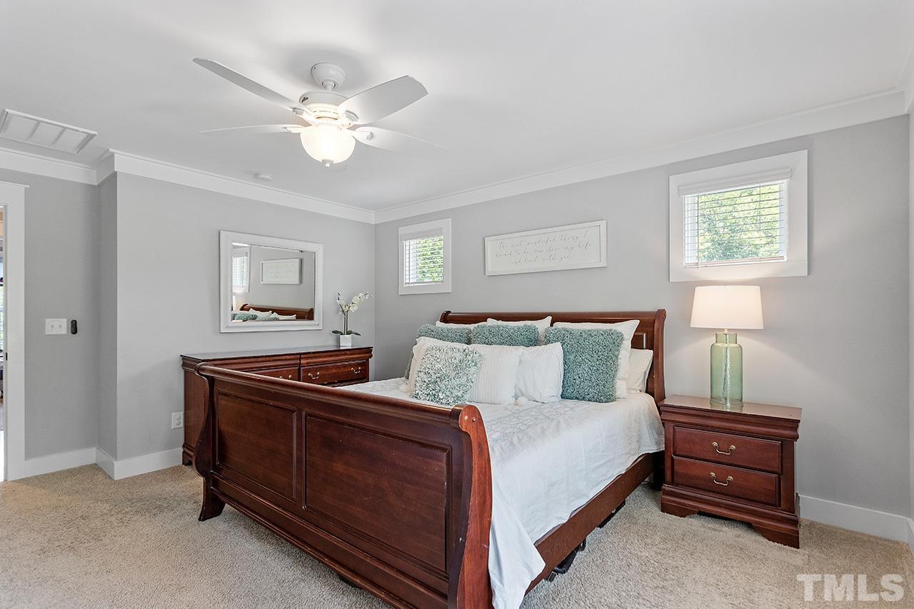 1417 Battery Drive Raleigh, NC 27610 - Photo 20 of 34 a bedroom with a bed and a chandelier