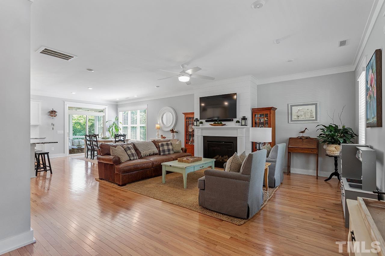 1417 Battery Drive Raleigh, NC 27610 - Photo 6 of 34 a living room with furniture a fireplace a flat screen tv and kitchen view