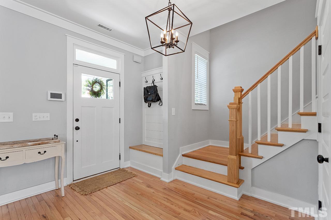1417 Battery Drive Raleigh, NC 27610 - Photo 7 of 34 a view of a hallway with wooden floor and staircase
