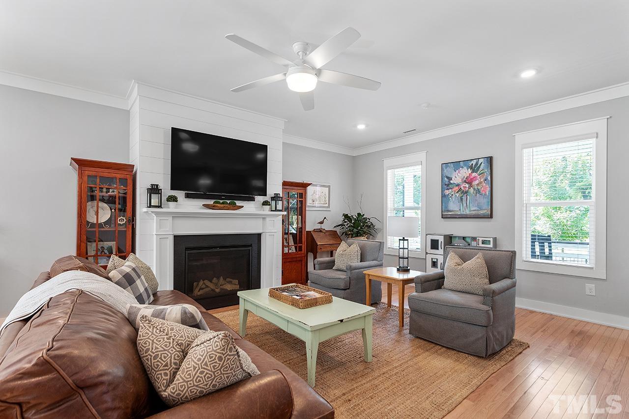 1417 Battery Drive Raleigh, NC 27610 - Photo 9 of 34 a living room with furniture a flat screen tv and a fireplace