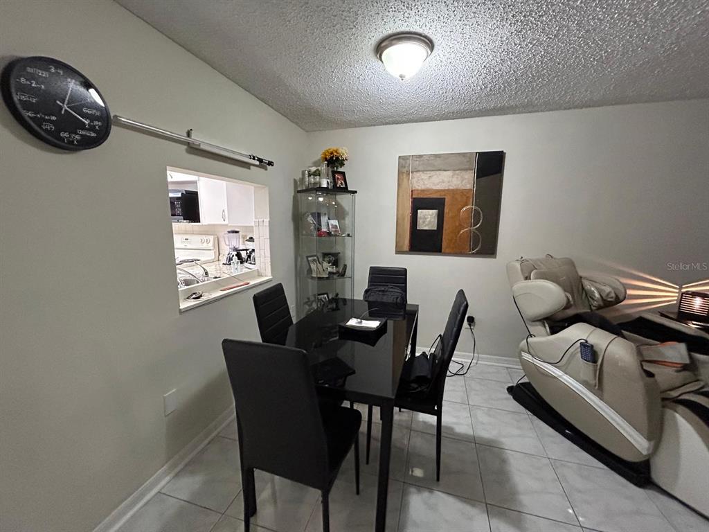Undisclosed Address New Port Richey, FL 34652 - Photo 13 of 25 a dining room with furniture and a window