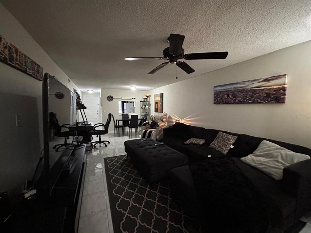 Undisclosed Address New Port Richey, FL 34652 - Photo 15 of 25 a living room with furniture and a ceiling fan