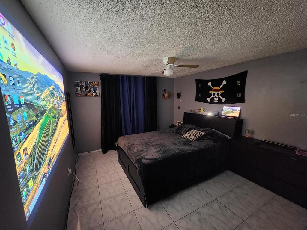 Undisclosed Address New Port Richey, FL 34652 - Photo 20 of 25 a living room with furniture and a flat screen tv