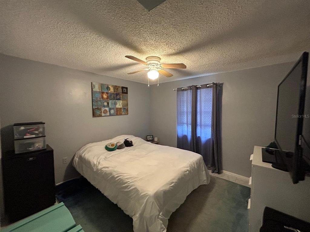 Undisclosed Address New Port Richey, FL 34652 - Photo 21 of 25 a bedroom with a bed and a flat screen tv