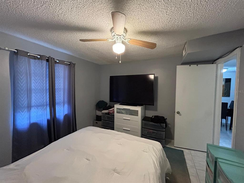 Undisclosed Address New Port Richey, FL 34652 - Photo 22 of 25 a bedroom with a bed and a flat screen tv